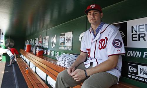 Lucas Giolito ’12 stands in the Washington Nationals dugout after signing with the organization. (Reprinted with permission of the Associated Press)