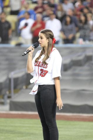 Megan Ward 13 sings the National Anthem before the first pitch.