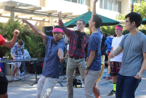 A group of seniors raise their arms while dancing in celebration of 80s Day.