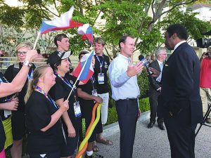 Hot Off The Press: President of Harvard-Westlake School Rick Commons talks to a CBS2 reporter about hosting the Special Olympics athletes. Men and women representing the Cuban teams stand behind him. (Photo courtesy of Stacy Marble.)