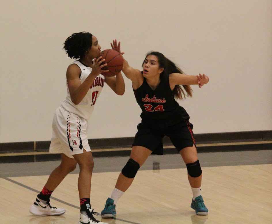Jayda Ruffus-Milner '18 attempts to pass the ball to a teammate while being guarded by an opponent. Credit: Pavan Tauh/Big Red