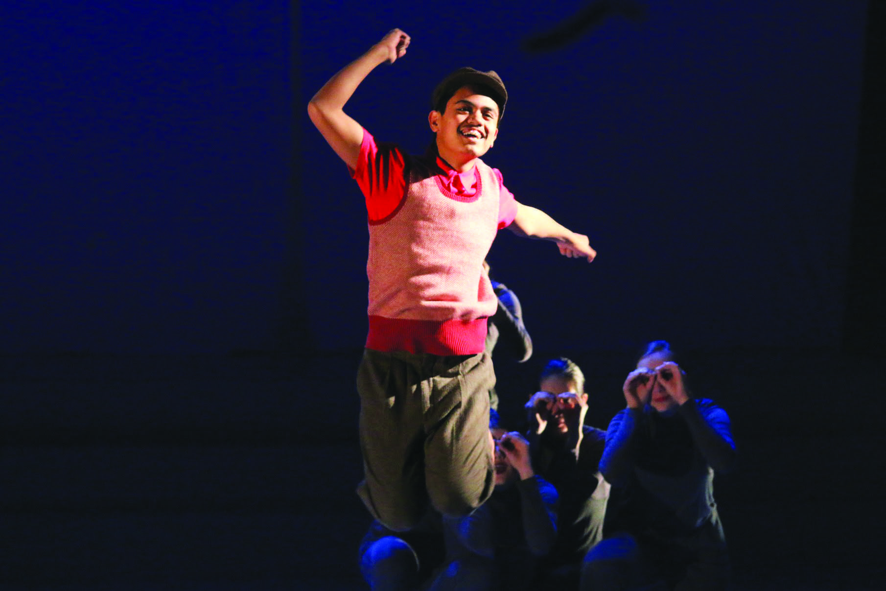 JUMP FOR JOY: Erick Gredonia ’17, who plays Charlie, celebrates after being given the key to Willy Wonka’s factory. Credit: Pavan Tauh/Chronicle