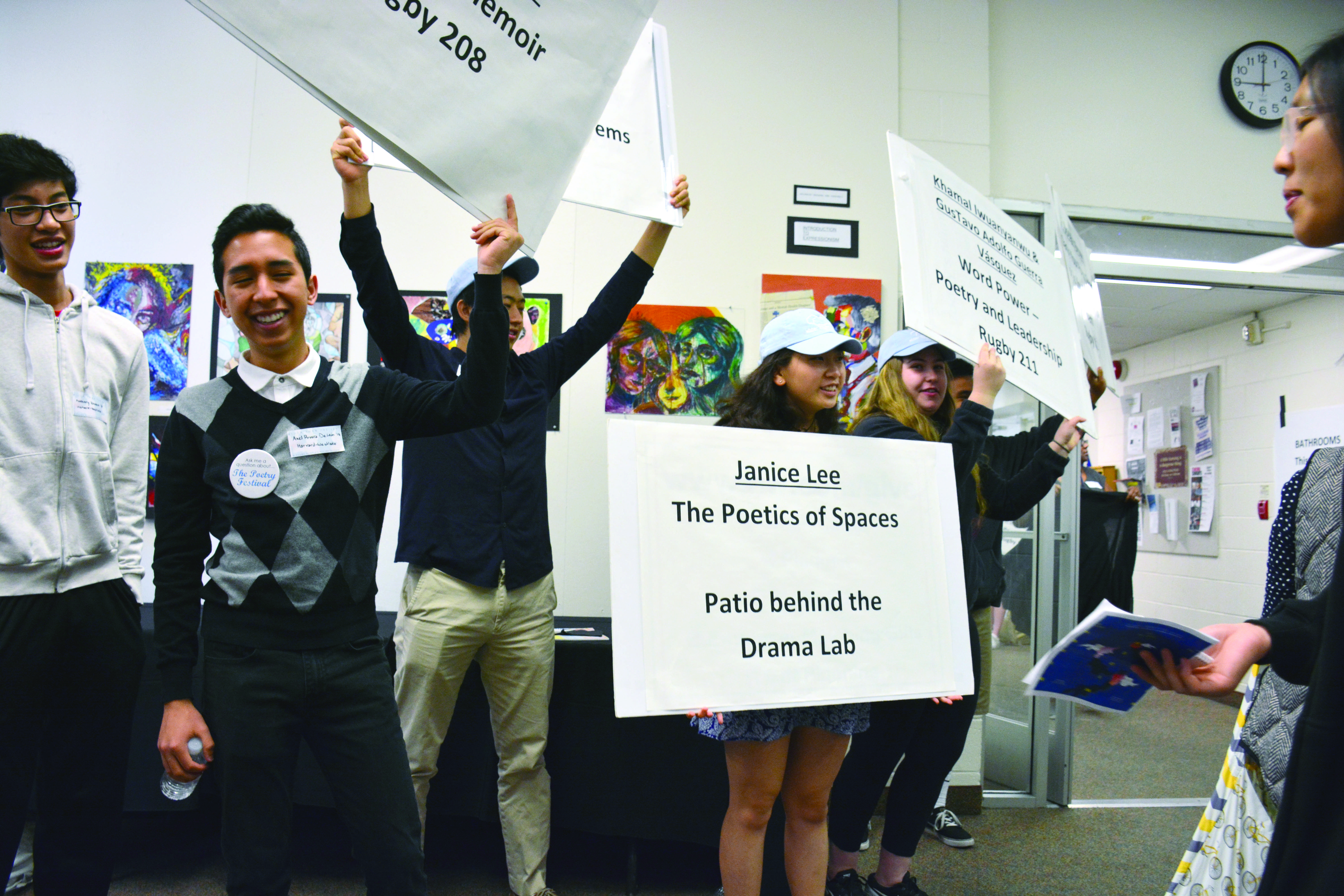 HUMAN DIRECTORIES: Harvard-Westlake ambassadors for “Wider than the Sky: A Young People’s Poetry Festival” hold up signs to direct festival participants. Credit: Teresa Suh/Chronicle