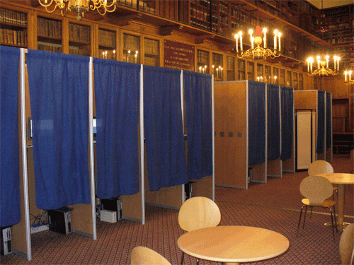 A typical voting booth. Image licensed for reuse with modification from Wikimedia Commons.