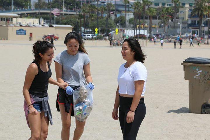 Justine Barraza 17, Sydney Tsutsui 17 and Stephanie Desoto 17 clean up trash in Santa Monica Beach. Printed with permission of Eitan Sneider.