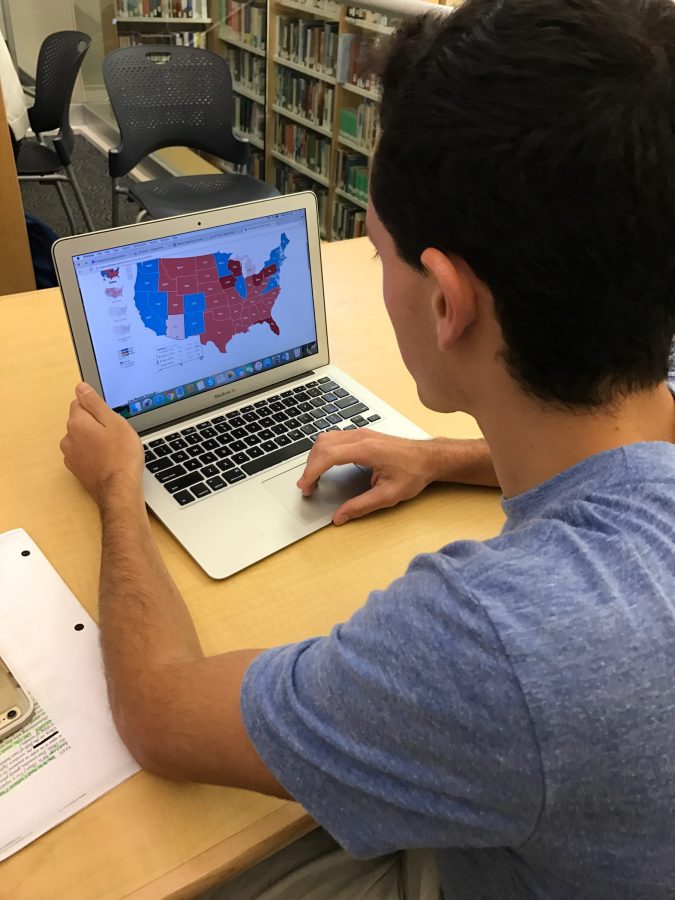 Jake Neuman 18 reviews the results of the election after Donald Trump was named the next President. Credit: Danielle Spitz/Chronicle 