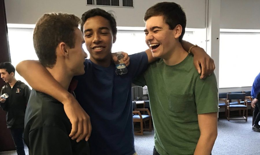 Will Granger ’18, Charles Flippen ’18 and Kevin Wesel ’17 (left to right) laugh as they reflect on their Peer Support training session. Mark Rosner spoke to the team.