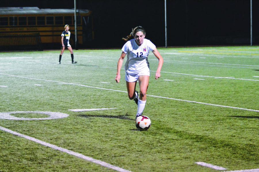 Forward Paige Howard ’17 chases the ball during the team’s 3-2 victory over Newbury Park last season. Credit: Credit Marx/Chronicle