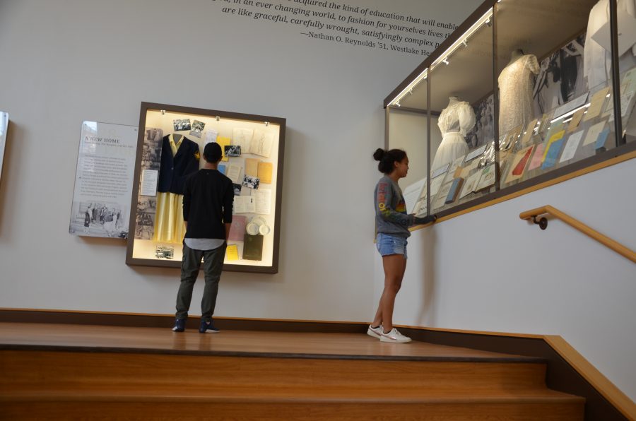 Mark Cho ’22 and Jade Stanford ’22 look at the Westlake archive display on the middle school campus. Credit: Kendall Dees/Chronicle