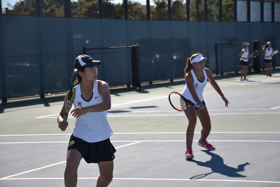 Girls+tennis+team+players+swing+in+a+match+versus+Notre+Dame.+Photo+Credit%3A+Elly+Choi+%2F+Chronicle