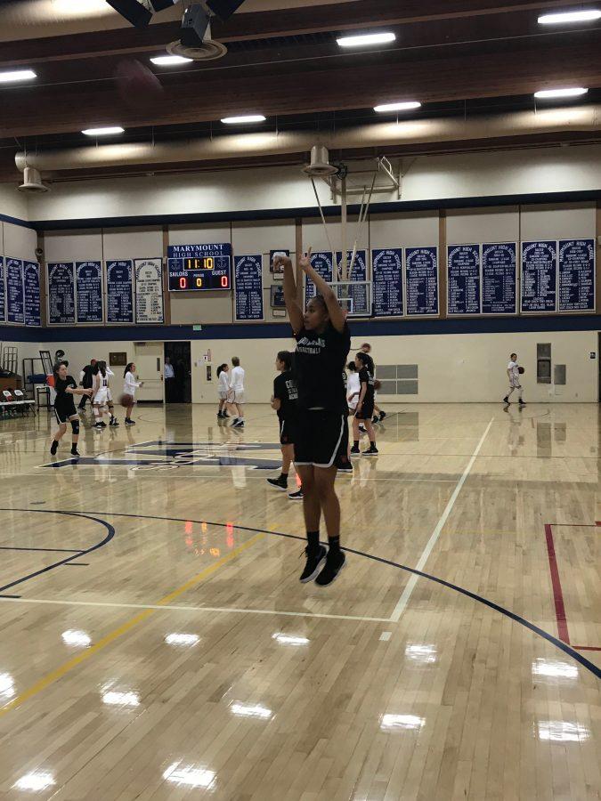 Genesis Aire 19 shoots the ball while warming up against Marymount. The team has beat Marymount in both games against them so far.

Photo Credit: Rileigh Repovich 20