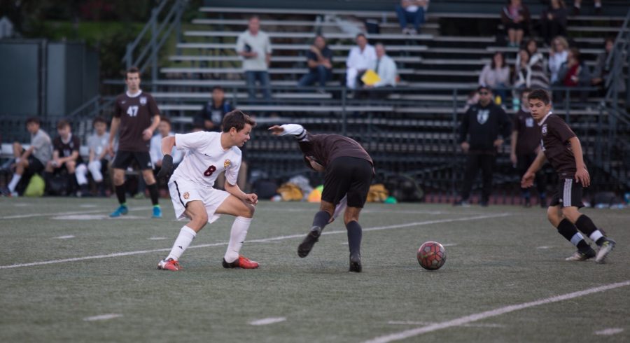 William Roskin ’18 jukes out opponent during Senior Night against Crespi. The team won the game 5-0. Photo Credit: Pavan Tauh/Chronicle