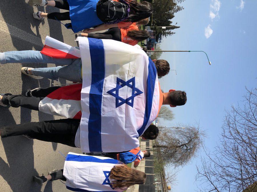 Students march with the Israeli flag on their backs at the March of the Living, an event that serves to educate students about the history of the Holocaust. Attendees travelled to Poland and Israel as part of the program for two weeks. Printed with permission of Jack Cohen 18