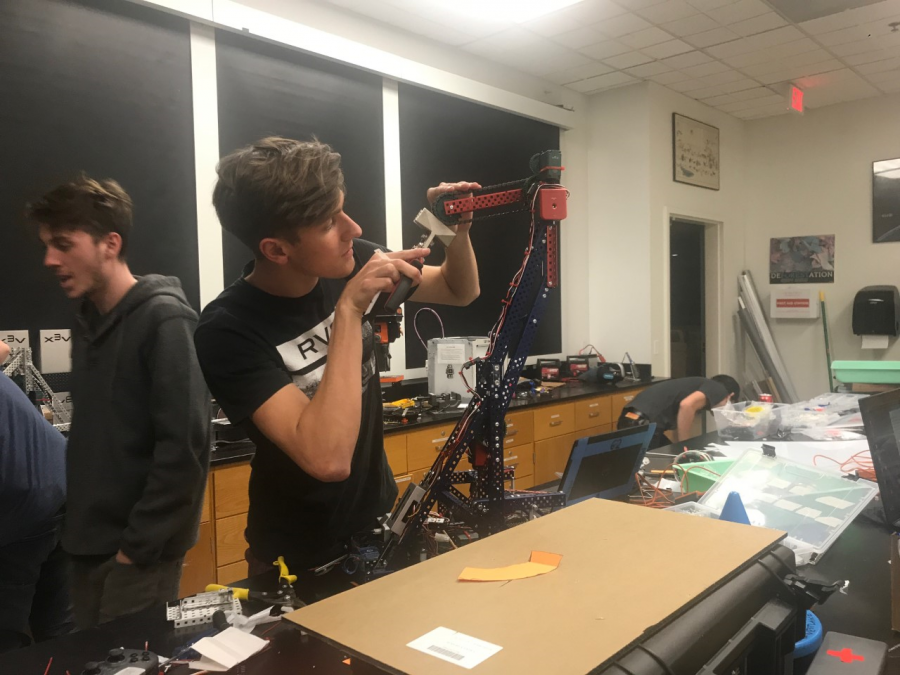 Cameron Schiller ’18 works on his robot the night before the VEX Robotics World competition in Louisville, KY. The team that qualified for World’s is comprised of Miles Agus ’18, Schiller and DJ Lesh ’18. The team has built six robots throughout this season. Sophie Haber/Chronicle