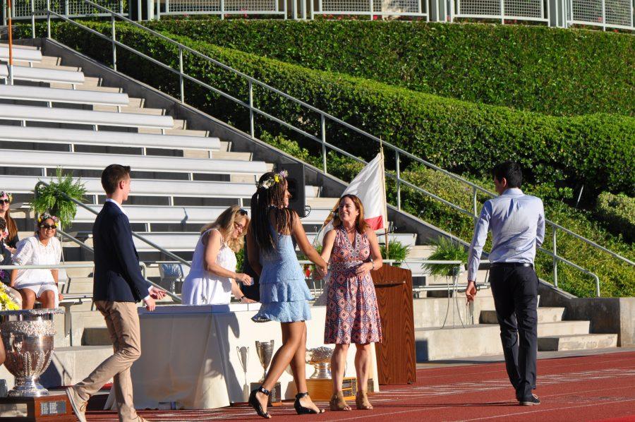 Head of Upper School Laura Ross presents seniors with their class rings. Credit: Noah Aire/Chronicle