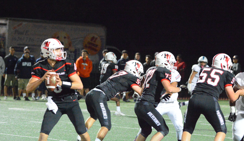 Quarterback Jameson Wang 20 throws the ball downfield during first quarter of their game against St. Paul last night.