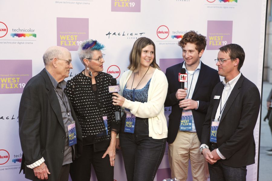 Annie Wendorf  ’19 and Jack Safir ’19 interview performing arts teacher Ted Walch, visual arts teacher Cheri Gaulke and visual arts teacher Jesse Chehak ’97 at the Westflix red carpet premier. The event featured writer and director Bo Burnham. Credit: Caitlin Chung