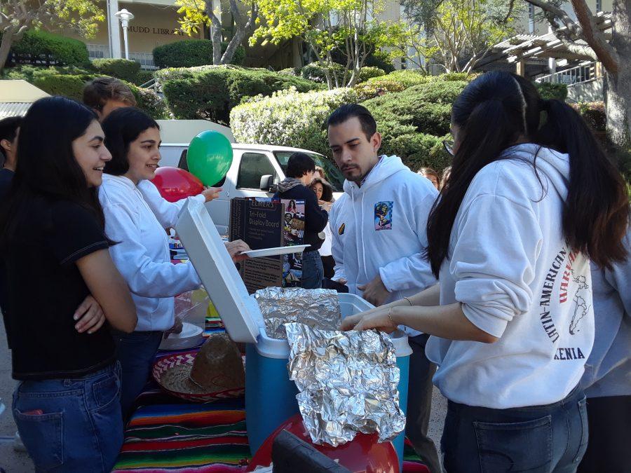 Students of LAHSO distribute food to students at the Multicultural Fair.  Credit: Tanisha Gunby/ Chronicle