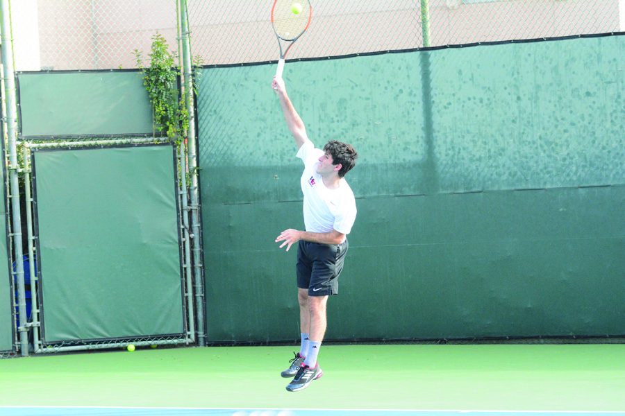 FRESHLY+SERVED%3A+David+Arkow+%E2%80%9920+serves+in+his+first+singles+match+in+a+15-3+victory+against+St.+Francis+High+School+on+Feb.+27.+Photo+credit%3A+Lucas+Lee+21.