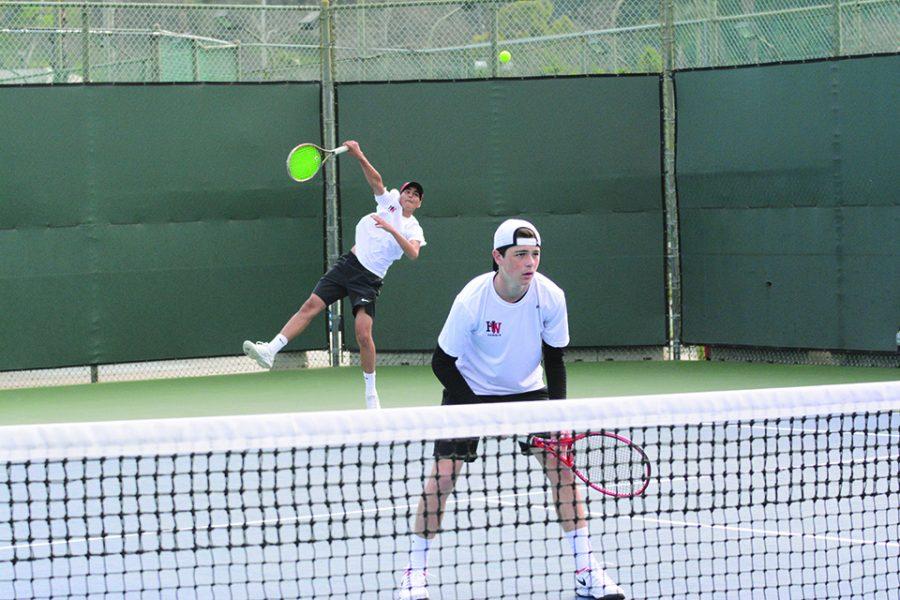 DUAL THREAT: Doubles player Avi Carson ’22 prepares for the opposing team to return Amaan Irfan’s ’21 serve Feb. 27. Photo credit: Lucas Lee/Chronicle.