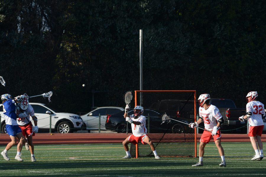 Goalie Alex Russell 19 defends a Chargers attack in the first quarter of the Wolverines 14-10 victory on Ted Slavin Field. The Wolverines will play Peninsula High School May 4 for a chance to advance to the final round. (Photo credit: Keila McCabe/Chronicle)