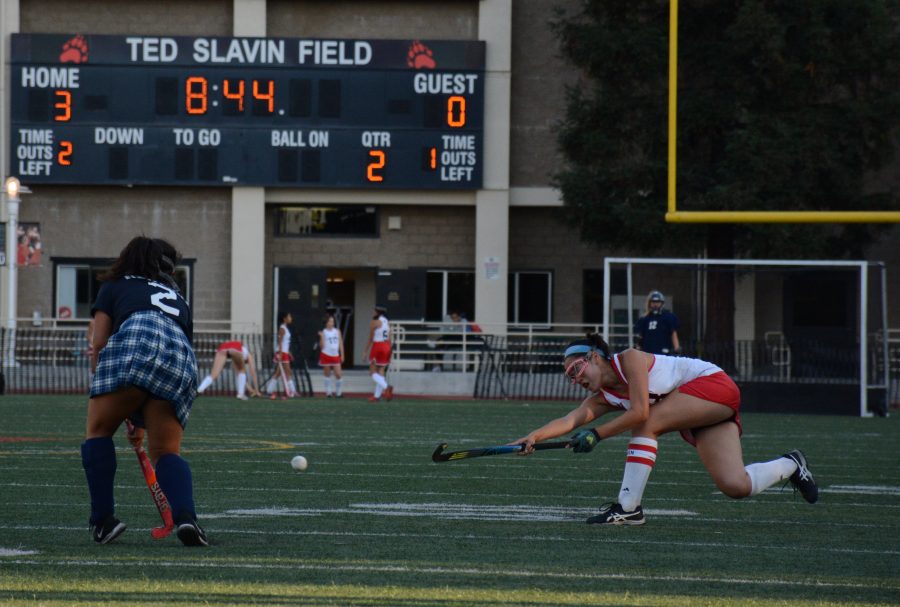 Chronicle staff member and field hockey co-captain, Astor Wu 20 passes the ball through the Newport Harbor defense. Credit: Lucas Lee/Chronicle