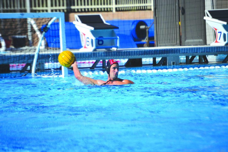 Killer Krutonog: Goalkeeper Nolan Krutonog ’20 surveys the pool for teammates in a game against Palos Verdes High School on Sept. 13, where they won with a score of 13-4. The Wolverines play their next match in the S&R Elite 8 Tournament from Oct. 3 to Oct 5. Credit: Sandra Koretz/Chronicle