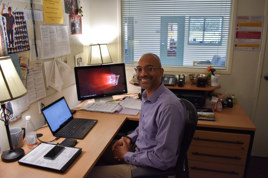 JONES STRIKES A POSE: Upper School Dean Chris Jones, who will replace Beth Slattery as Upper School Deans Department Head beginning July 1, 2020, sits in his office and smiles.
Frank Jiang / Chronicle
