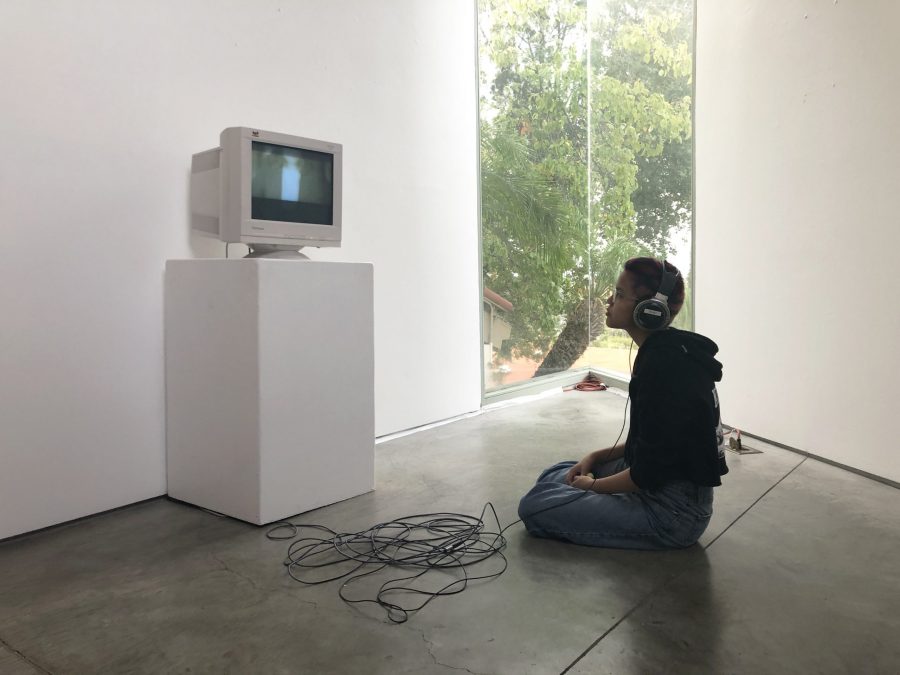 Sophia Nuñez ’20 watches a video art installation created by Anna Katz ’20 called “Rorschach” in Feldman-Horn Gallery. The installation showcased work by both students and faculty. Credit: Tanisha Gunby/Chronicle
