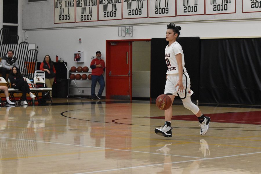 Guard Melissa Zozulenko 21 dribbles the ball up the court in a 75-31 win against La Canada High School in the Brentwood Invitational. Zozulenko made the game-winning free throw for the Wolverines against Chaminade High School