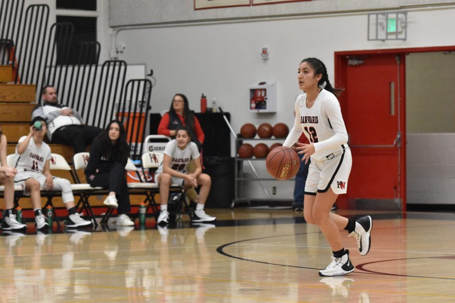 Guard Paula Gonzalez 21 surveys the court for teammates in a 75-31 win against La Canada High School in the Brentwood Invitational on Dec. 7. Credit: Jaidev Pant/Chronicle