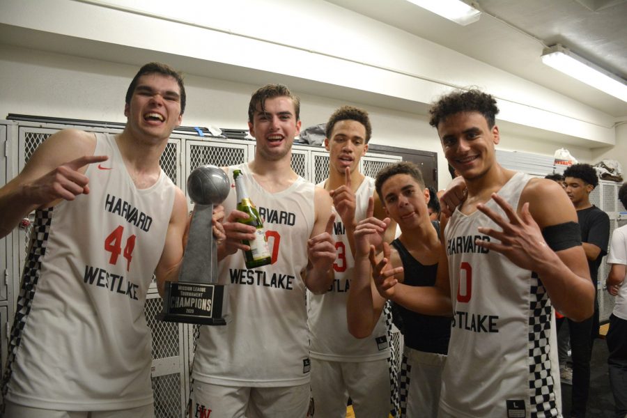 Mason Hooks 20, Trumann Gettings 21, Brase Dottin 20, Spencer Hubbard 20 and Holden McRae 20 celebrate their second consecutive Mission League title with the trophy a bottle of cider.