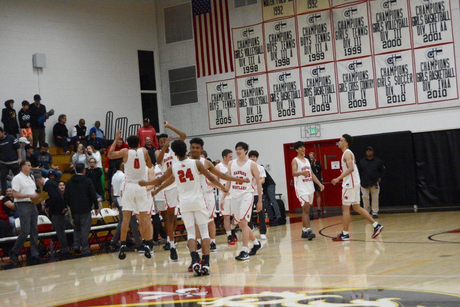 The+Wolverines+celebrate+their+63-55+victory+over+Centennial+High+School+Wed%2C+Mar.+5.+The+team+takes+on+Sierra+Canyon+School+on+Saturday+at+7+p.m.+Credit%3A+Kyle+Reims%2FChronicle