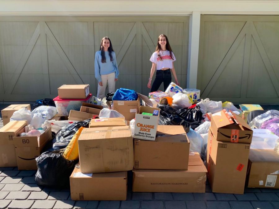 Julianna Ross 22 and Kendra Ross 23 pose behind the donations they received for Casa Hogar Sonrisa de Ángeles, which is located in Tijuana, Mexico.