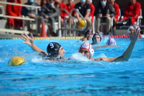 No. 9 Len Korol 21 keeps the ball underwater as a defensive tactic. Winning their fifth game of the season, the Wolverines bring their teams season record to 4-1.