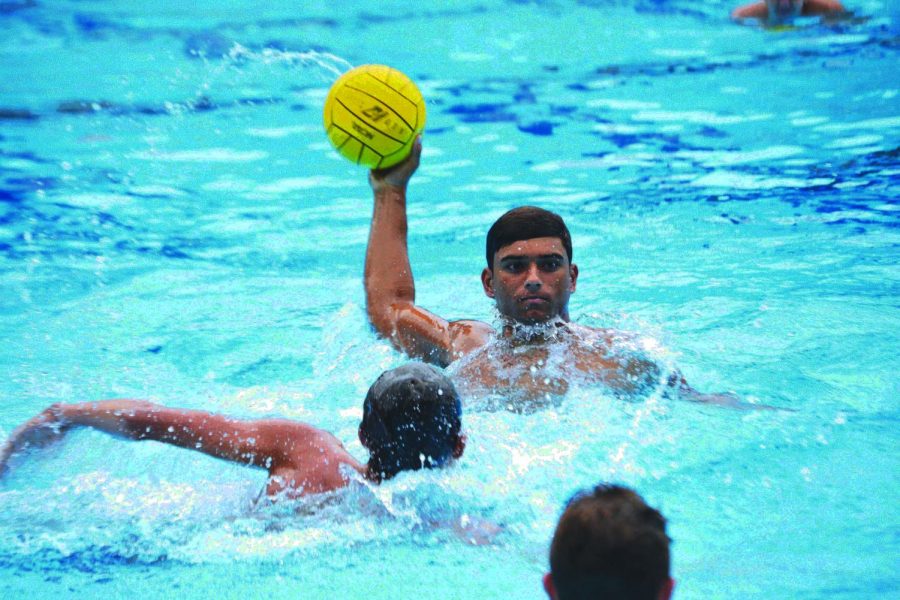 Shooting into season: Jack Burghardt ’23 winds up to gather power before shooting the ball between two defenders in the team’s pre-season training. Boys water polo looks to start its season off strong in its Mission League home opener against St. Francis High School on Aug. 25.