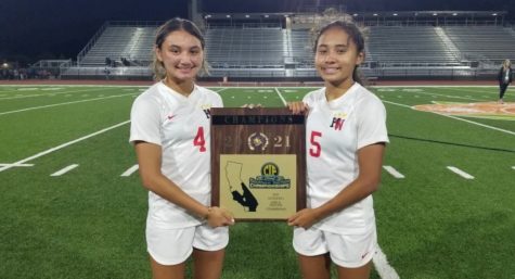 Holding the CIF SoCal State Championship trophy, the Thompson sisters pose for a photo after handling Pacifica High School 6-1