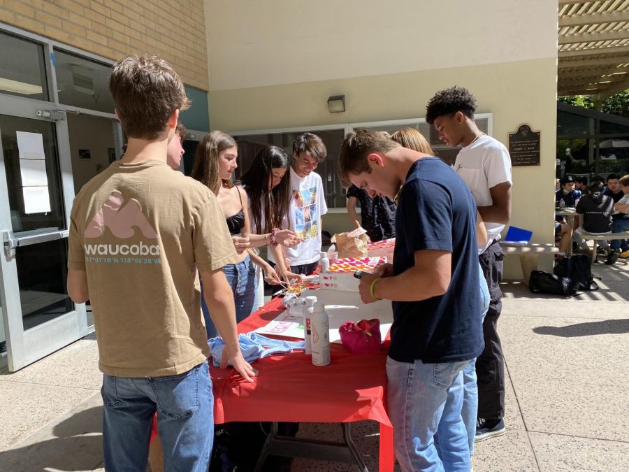 Upper school students crowd around the booth outside Chalmers to complete their registration and receive Dunkin Donuts, with their Social Security numbers in hand.