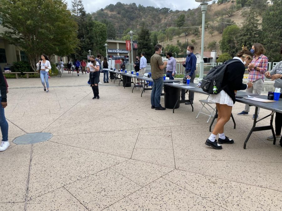 Before school starts, students gather on the fire road in order to be tested for COVID-19. This testing occurs weekly, with sophomores, juniors and seniors being tested on different days.
