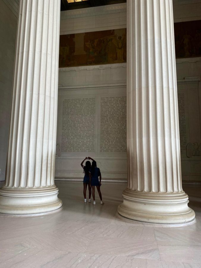 Ella Watkins 22 and Olivia Sparks 22 gaze upward during their Junior Fellowship at the Lincoln Memorial in Washington D.C.