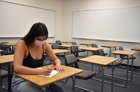 Shanti Hinkin 22 takes her test in an empty classroom. 