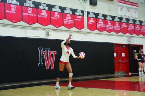 Ready to strike: Avery Jones ’23 tosses up a serve in a 3-0 victory against Westview High School in the first round of CIF State Playoffs.