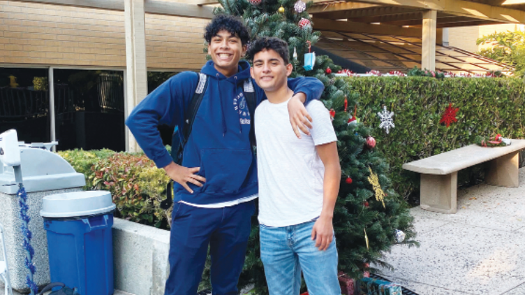 Rohan Mehta ’23 and Alejandro Lombard ’23 pose in front of the Christmas tree on the Quad. Prefect Council placed presents under the tree for winners of the “Rick on the Commons” contest.