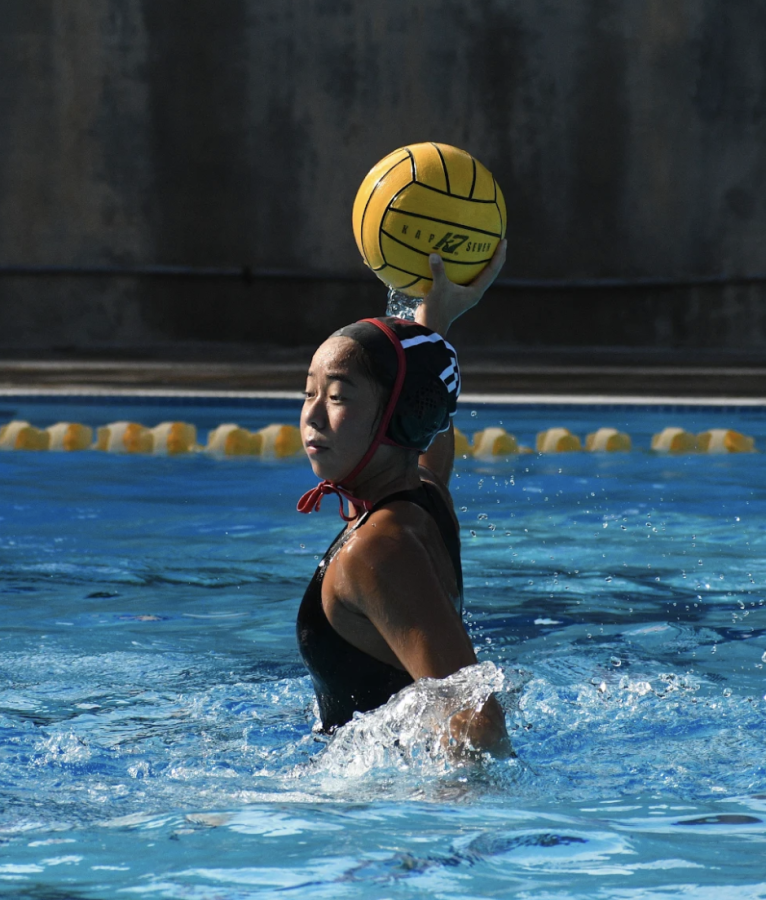 At+the+girls+water+polo+game+against+Louisville+High+School%2C+Jasmine+Tang+24+prepares+to+pass+the+ball+to+her+teammate.