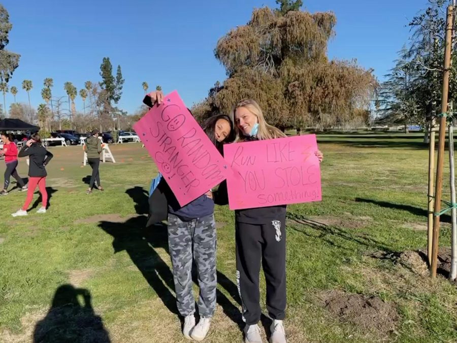 Daniela Quintero 22 and Makenna Dovel 23 pose with encouraging signs at the WeSPARK event.