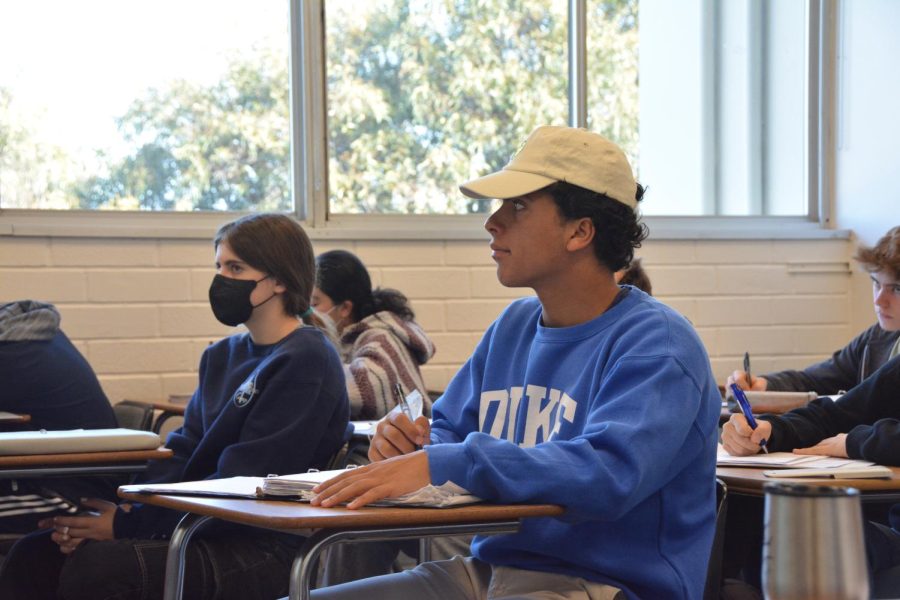 Logan Azizzideh ’24 takes notes during a lecture in his Honors Algebra II course. For the first time in more than two years, Azizzideh was able to attend a class without having to wear a mask after the administration removed the school’s indoor mask requirement.