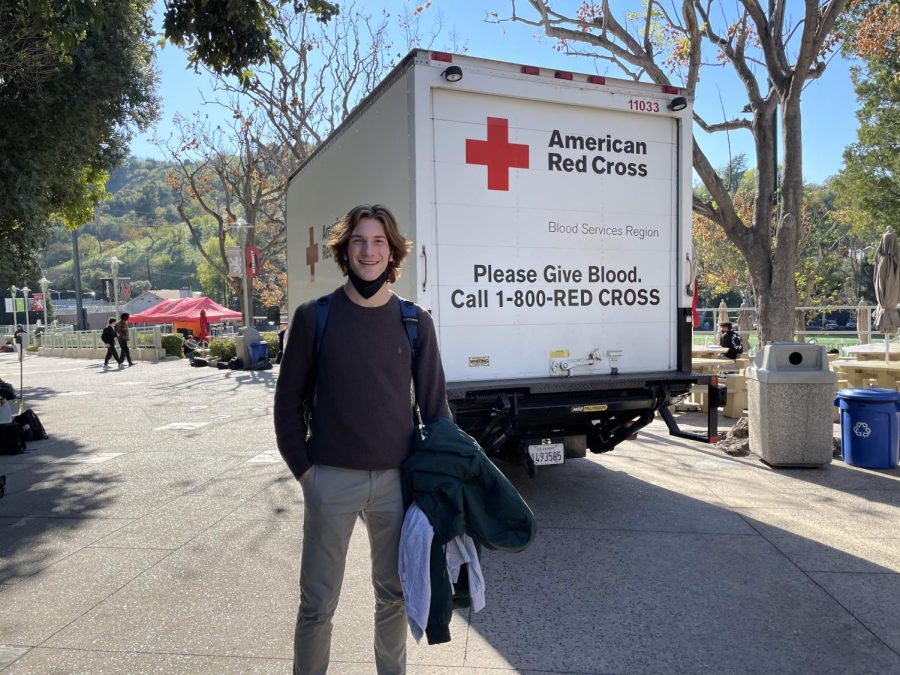 Nuzzy Sykes 24 poses next to an American Red Cross truck driven onto campus for the blood drive.