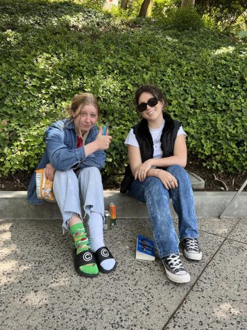 Goldie Grube 23 and Ella Goldberg 23 pose in jean clothing they wore in honor of Denim Day on April 27.