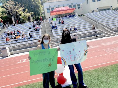 Charlotte Newman 24 and Illi Kreiz 24 cheer on participants at a Special Olympics event organized by Community Council.