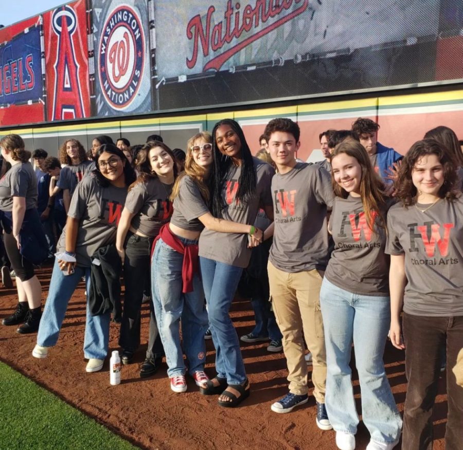 Members of Chamber Singers, Bel Canto, Wolverine Chorus and Jazz Singers prepare to sing the National Anthem alongside other school choirs at Angel Stadium.